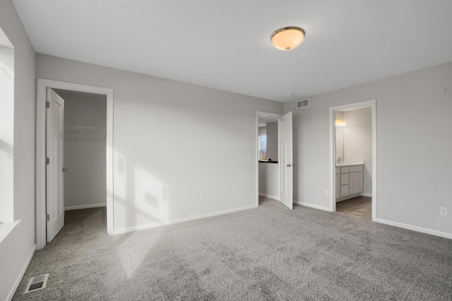 10647 29th St NE, Saint Michael, MN 55376 - unfurnished bedroom featuring carpet, baseboards, a walk in closet, and ensuite bath