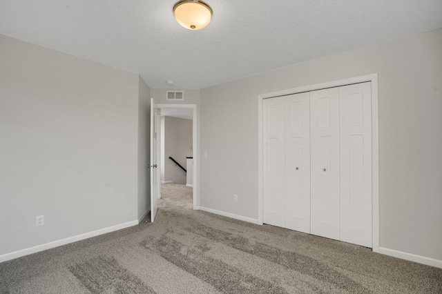10647 29th St NE, Saint Michael, MN 55376 - unfurnished bedroom featuring carpet floors, baseboards, a closet, and a textured ceiling