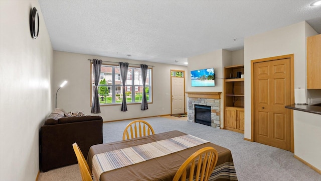 13749 Atrium Ave Unit 2303, Rosemount, MN 55068 - dining space featuring light colored carpet, a textured ceiling, a fireplace, and baseboards