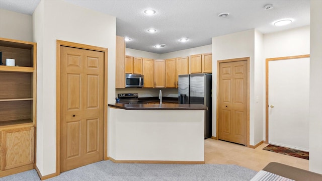13749 Atrium Ave Unit 2303, Rosemount, MN 55068 - kitchen featuring appliances with stainless steel finishes, dark countertops, a peninsula, a textured ceiling, and light brown cabinetry