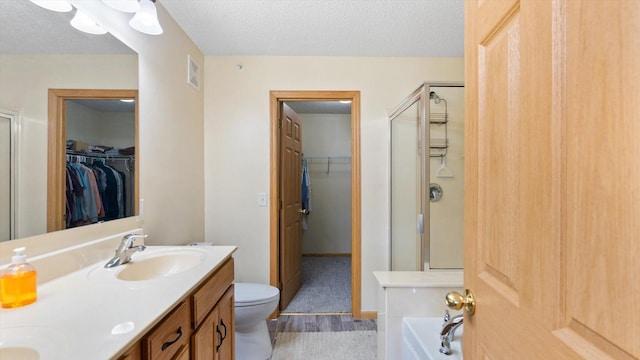 13749 Atrium Ave Unit 2303, Rosemount, MN 55068 - bathroom with a stall shower, a textured ceiling, double vanity, and a spacious closet