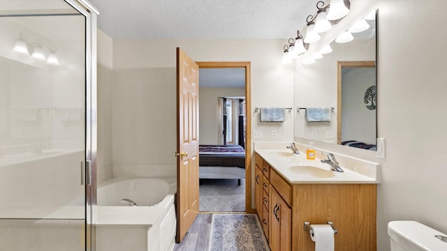 13749 Atrium Ave Unit 2303, Rosemount, MN 55068 - bathroom with a garden tub, double vanity, a textured ceiling, a stall shower, and wood finished floors