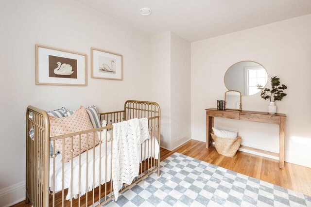 2137 Wellesley Ave, Saint Paul, MN 55105 - bedroom featuring wood finished floors and a crib