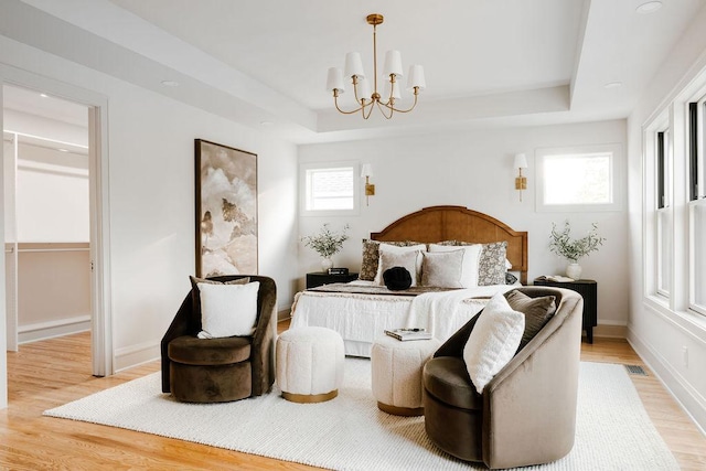 2137 Wellesley Ave, Saint Paul, MN 55105 - bedroom with a raised ceiling, light wood-style flooring, and a chandelier