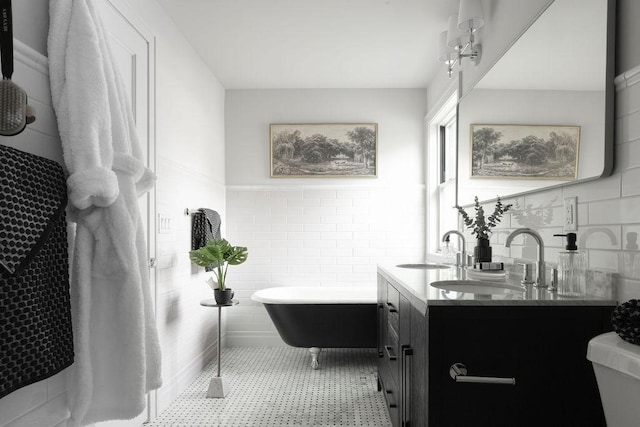 2137 Wellesley Ave, Saint Paul, MN 55105 - bathroom with tile walls, a freestanding bath, double vanity, and wainscoting