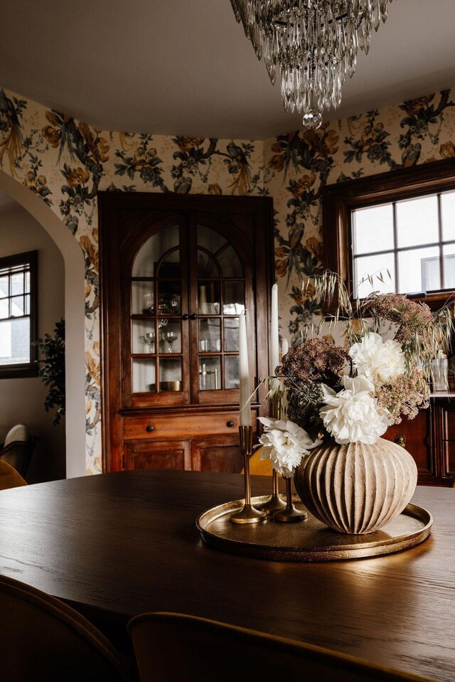 2137 Wellesley Ave, Saint Paul, MN 55105 - dining space featuring wallpapered walls, arched walkways, and a chandelier