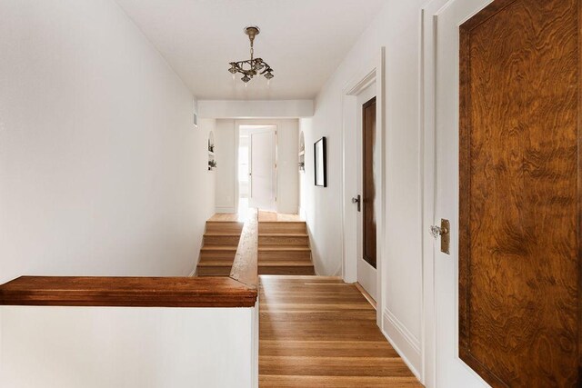 2137 Wellesley Ave, Saint Paul, MN 55105 - staircase featuring wood finished floors and a chandelier