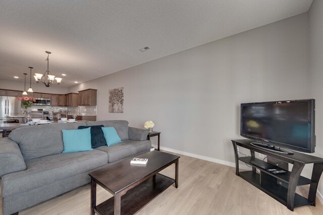 2605 Hanson Ave, Faribault, MN 55021 - living area with light wood-style flooring, baseboards, a chandelier, and recessed lighting