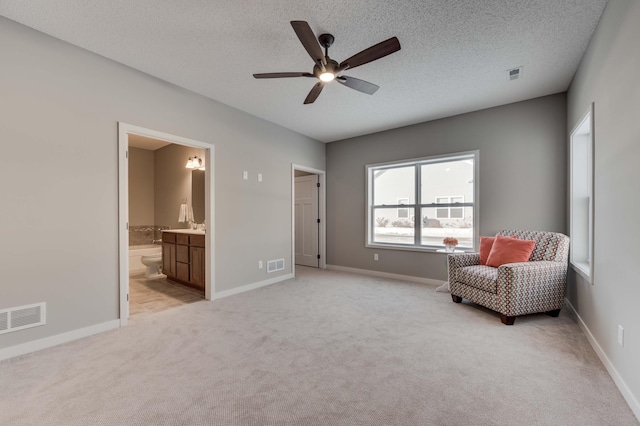 2605 Hanson Ave, Faribault, MN 55021 - sitting room with ceiling fan, light carpet, a textured ceiling, and baseboards