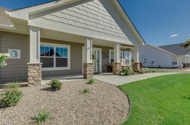 2605 Hanson Ave, Faribault, MN 55021 - craftsman house with a porch, a front yard, and stone siding