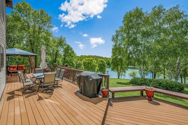 17002 260th St, Franconia Twp, MN 55045 - wooden terrace featuring outdoor dining area, a water view, and a yard