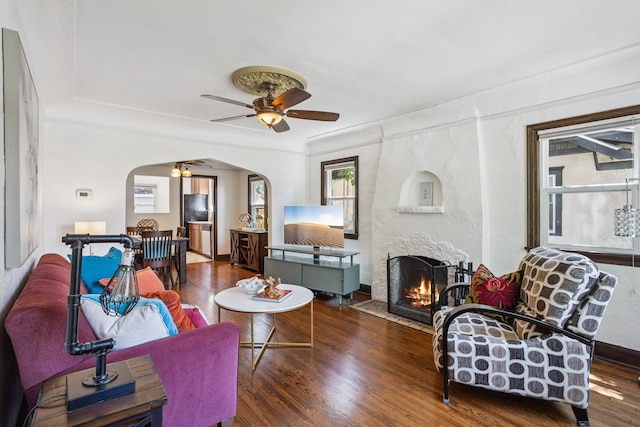 4545 5th Ave S, Minneapolis, MN 55419 - living area with arched walkways, wood finished floors, a ceiling fan, and a fireplace with flush hearth