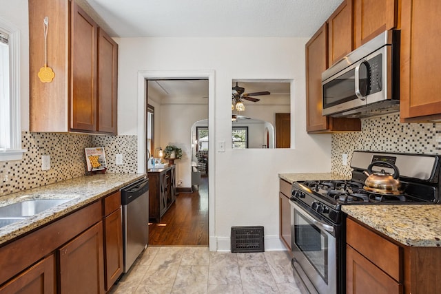 4545 5th Ave S, Minneapolis, MN 55419 - kitchen featuring appliances with stainless steel finishes, a ceiling fan, healthy amount of natural light, and tasteful backsplash