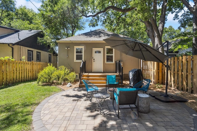 4545 5th Ave S, Minneapolis, MN 55419 - rear view of house with stucco siding, a patio area, and roof with shingles