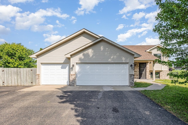 6122 152nd St N, Hugo, MN 55038 - view of front of home with driveway, a garage, stone siding, and roof with shingles