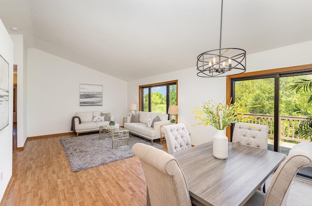 6122 152nd St N, Hugo, MN 55038 - dining area featuring a chandelier, light wood-type flooring, lofted ceiling, and baseboards