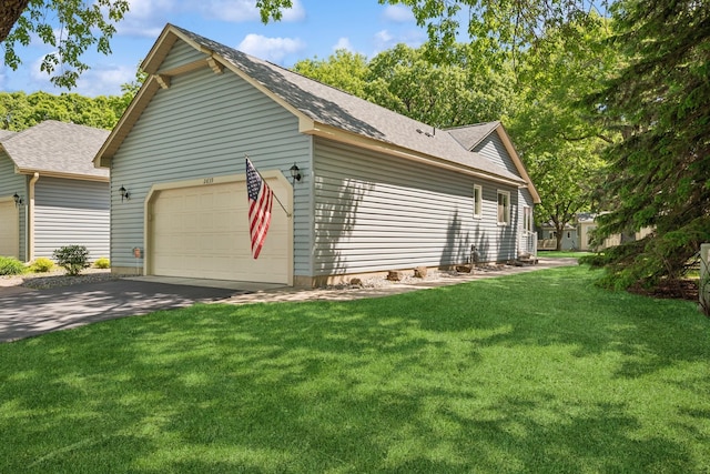 2639 Lake Court Cir Unit 81, Mounds View, MN 55112 - view of property exterior with an attached garage, a yard, a shingled roof, and driveway