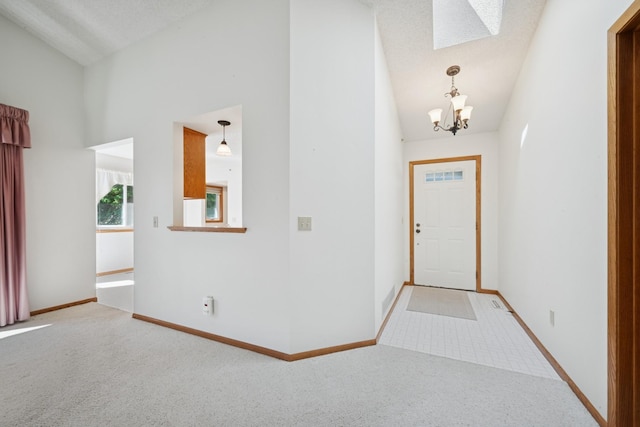 2639 Lake Court Cir Unit 81, Mounds View, MN 55112 - carpeted entrance foyer featuring a chandelier, baseboards, a skylight, and high vaulted ceiling