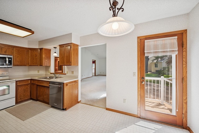 2639 Lake Court Cir Unit 81, Mounds View, MN 55112 - kitchen featuring stainless steel appliances, a sink, light countertops, and brown cabinetry