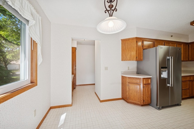 2639 Lake Court Cir Unit 81, Mounds View, MN 55112 - kitchen featuring stainless steel fridge, brown cabinetry, plenty of natural light, and light countertops