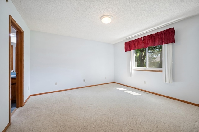 2639 Lake Court Cir Unit 81, Mounds View, MN 55112 - carpeted spare room featuring baseboards and a textured ceiling
