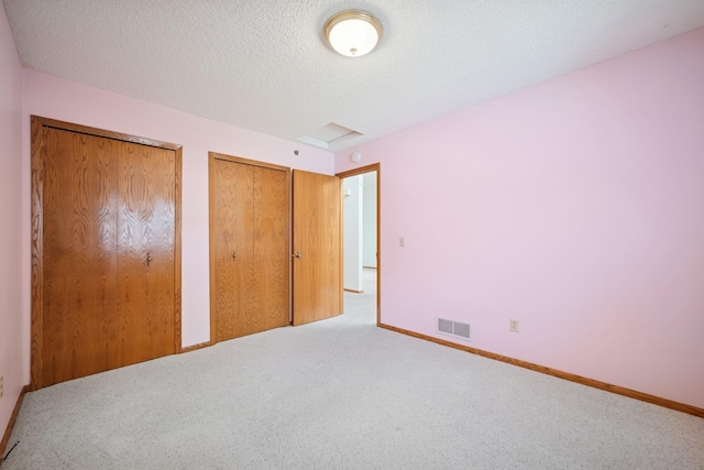 2639 Lake Court Cir Unit 81, Mounds View, MN 55112 - unfurnished bedroom featuring multiple closets, carpet flooring, a textured ceiling, and baseboards