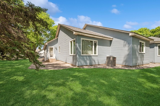 2639 Lake Court Cir Unit 81, Mounds View, MN 55112 - view of side of home featuring a patio, a yard, central air condition unit, and a shingled roof