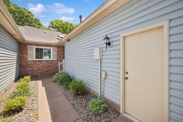 2639 Lake Court Cir Unit 81, Mounds View, MN 55112 - view of exterior entry with brick siding and roof with shingles
