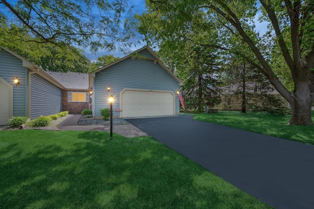 2639 Lake Court Cir Unit 81, Mounds View, MN 55112 - view of front of house with a front yard, an attached garage, and asphalt driveway
