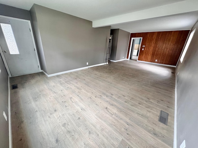 301 Legion Field Rd, Marshall, MN 56258 - unfurnished living room with wood finished floors, baseboards, and wood walls