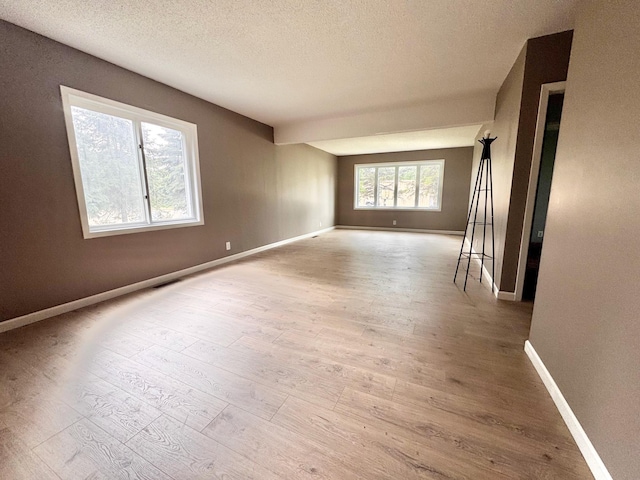 301 Legion Field Rd, Marshall, MN 56258 - empty room featuring wood finished floors, a textured ceiling, and baseboards