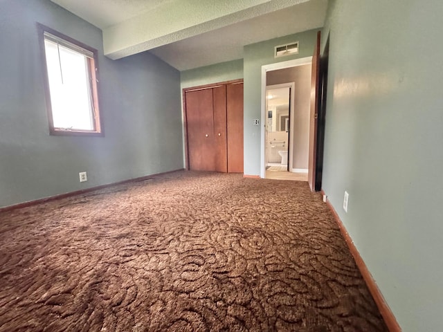 301 Legion Field Rd, Marshall, MN 56258 - unfurnished bedroom with carpet flooring, a closet, and baseboards