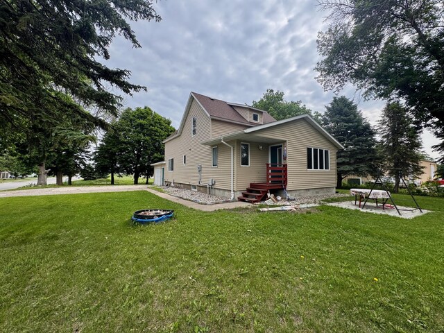 301 Legion Field Rd, Marshall, MN 56258 - view of home's exterior featuring an outdoor fire pit and a yard