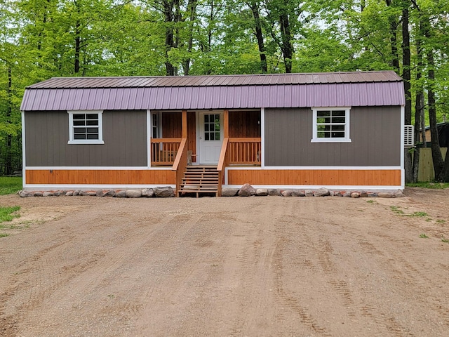 46625 High Dr, Kathio Twp, MN 56450 - manufactured / mobile home with metal roof, a porch, a gambrel roof, and view of wooded area