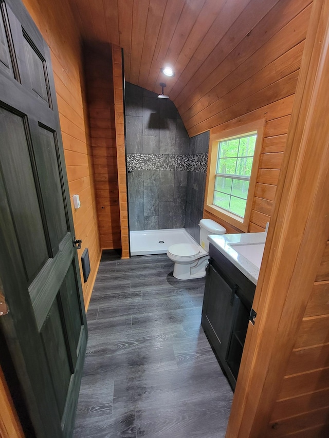 46625 High Dr, Kathio Twp, MN 56450 - full bathroom featuring wooden walls, lofted ceiling, toilet, vanity, and tiled shower