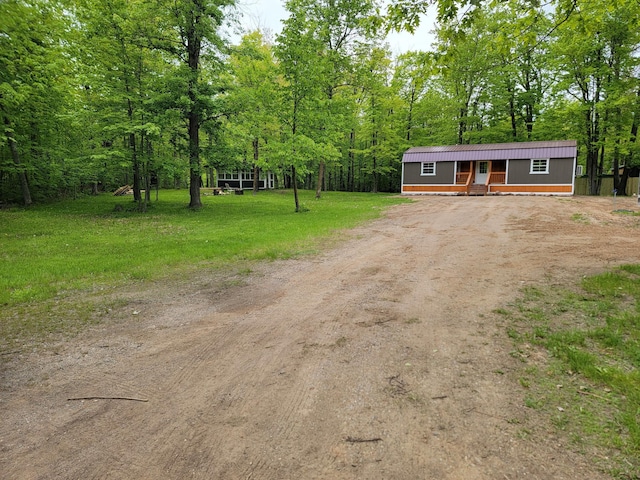 46625 High Dr, Kathio Twp, MN 56450 - manufactured / mobile home featuring dirt driveway, a wooded view, and a front yard