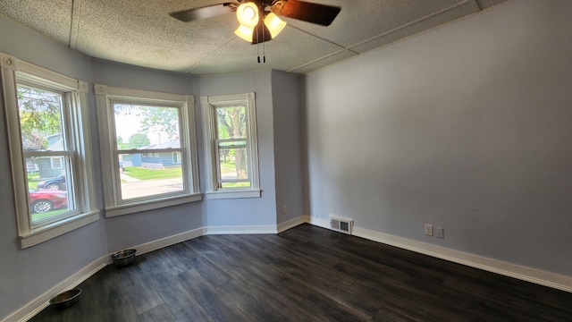 229 2nd Ave, Wanamingo, MN 55983 - spare room with dark wood finished floors, a ceiling fan, and baseboards