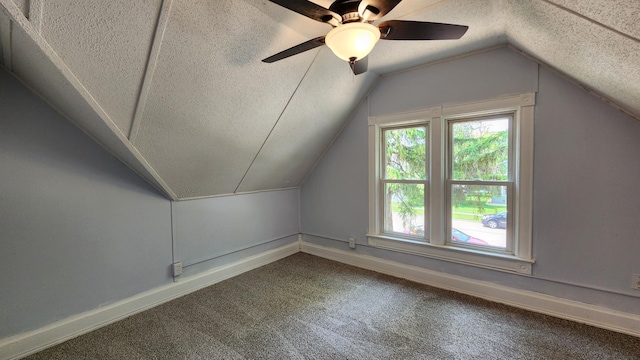 229 2nd Ave, Wanamingo, MN 55983 - additional living space with a textured ceiling, carpet floors, lofted ceiling, baseboards, and ceiling fan