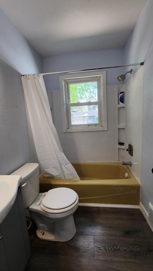 229 2nd Ave, Wanamingo, MN 55983 - full bath with wood finished floors, toilet, shower / bath combination with curtain, and vanity