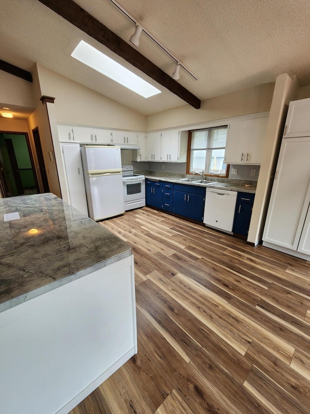 1180 Hathaway Ln NE, Fridley, MN 55432 - kitchen featuring blue cabinets, white appliances, track lighting, a sink, and dark wood-style flooring