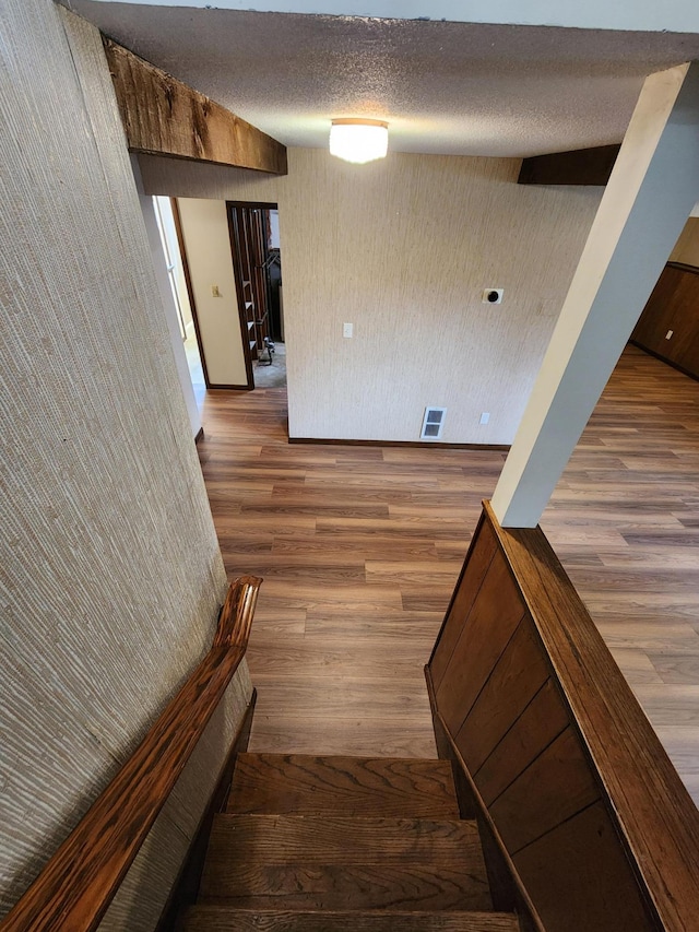 1180 Hathaway Ln NE, Fridley, MN 55432 - stairway with wood finished floors and a textured ceiling