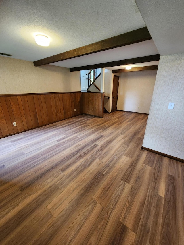 1180 Hathaway Ln NE, Fridley, MN 55432 - finished basement with a textured ceiling, wood finished floors, and stairway