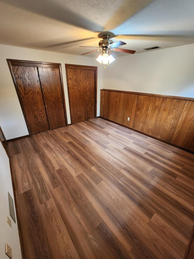 1180 Hathaway Ln NE, Fridley, MN 55432 - unfurnished bedroom with wood finished floors, multiple closets, and a ceiling fan