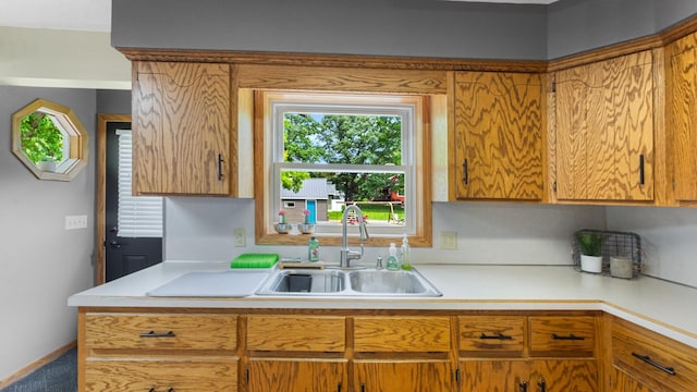 401 Main St, Osakis, MN 56360 - kitchen with a sink, light countertops, and brown cabinetry