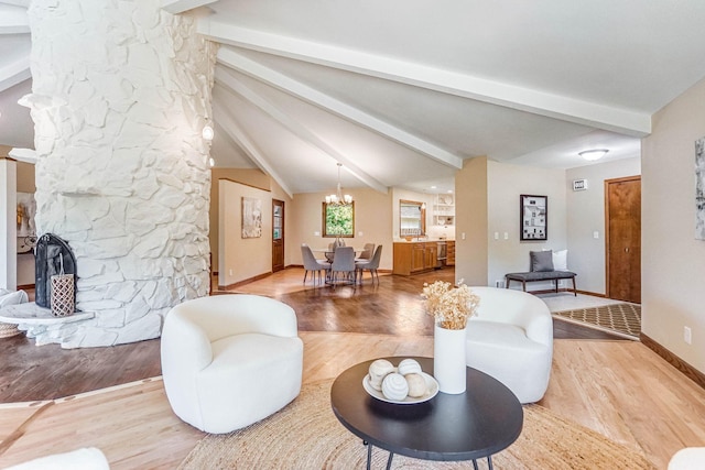 1000 Winston Cir, Mendota Heights, MN 55118 - living room with a stone fireplace, light wood-type flooring, baseboards, and a chandelier