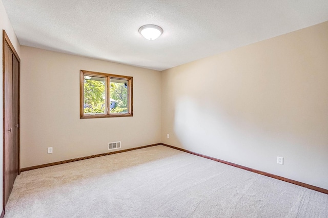 1000 Winston Cir, Mendota Heights, MN 55118 - unfurnished bedroom featuring light carpet, a textured ceiling, baseboards, and a closet