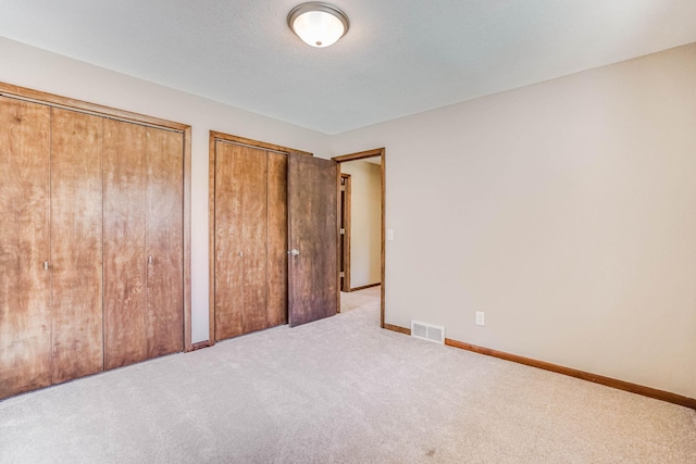 1000 Winston Cir, Mendota Heights, MN 55118 - unfurnished bedroom with two closets, carpet floors, and baseboards