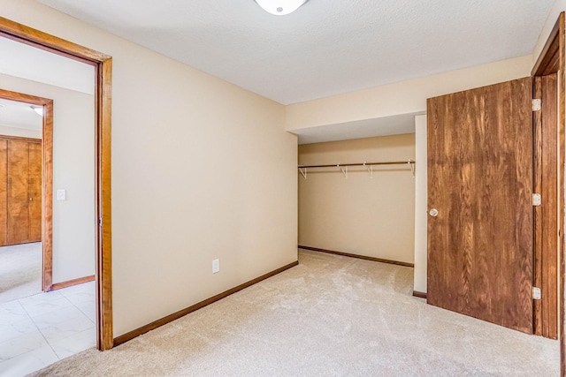 1000 Winston Cir, Mendota Heights, MN 55118 - unfurnished bedroom featuring a closet, marble look tile flooring, baseboards, and carpet flooring