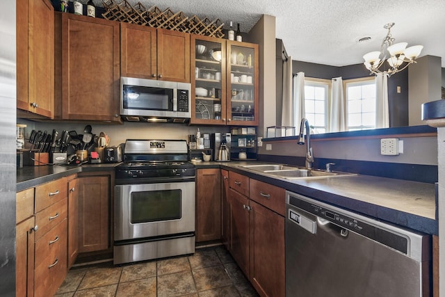 15359 Foliage Ave Unit 501, Apple Valley, MN 55124 - kitchen with appliances with stainless steel finishes, dark countertops, glass insert cabinets, a chandelier, and a textured ceiling