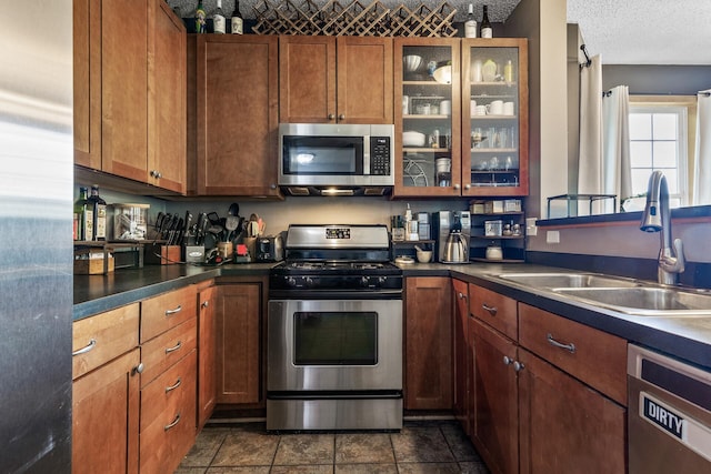 15359 Foliage Ave Unit 501, Apple Valley, MN 55124 - kitchen featuring stainless steel appliances, dark countertops, glass insert cabinets, and brown cabinets